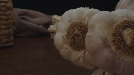 Fresh-garlics-on-table,-dolly-backward-probe-lens-macro-view