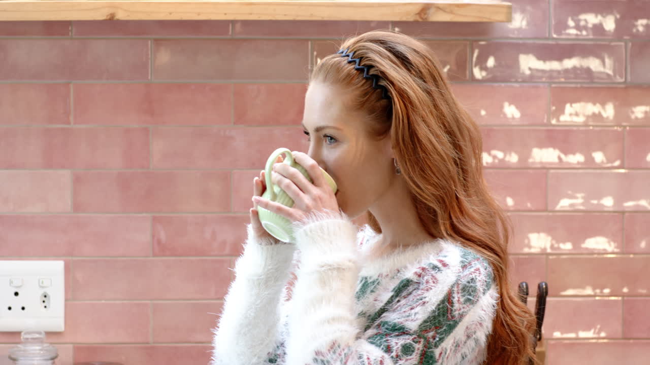 Christmas time, Woman enjoying warm drink at home, wearing cozy sweater, feeling relaxed