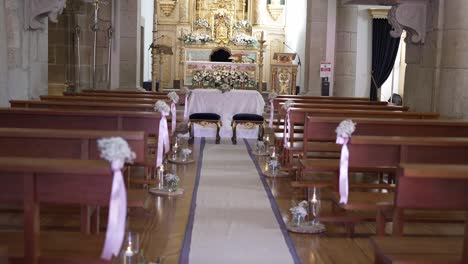 interior of a beautifully decorated church aisle with floral arrangements and ornate altar