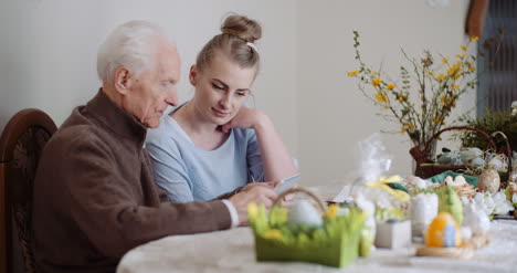 Granddaughter-With-Grandfather-Using-Digital-Tablet-1