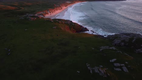 Titling-Reveal-of-Sandy-Beach-at-Sunset-on-Isle-of-Coll,-Hebrides,-Scotland