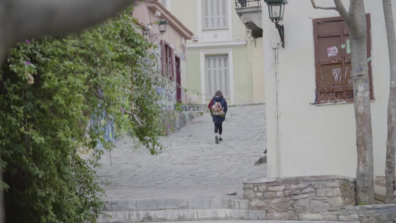Girl walking through the streets of Athens, Greece in slow motion lonely lonely every day life