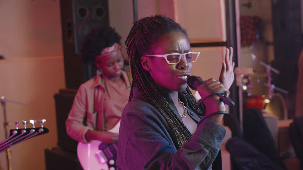 Multiethnic Music Band Rehearsing In Recording Studio 15