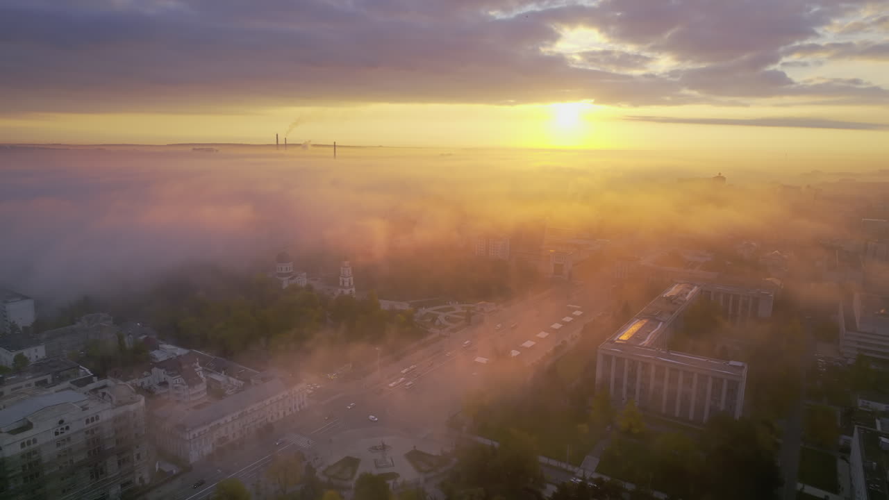 Aerial drone view of Chisinau at sunrise, Moldova. View of city centre covered with fog and low clouds. Central Park, Goverment building
