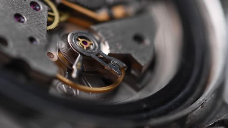 mecanismo de trabajo interno del reloj de pulsera con un péndulo y engranajes que giran rápidamente. reloj 4k de primer plano con poca profundidad de campo