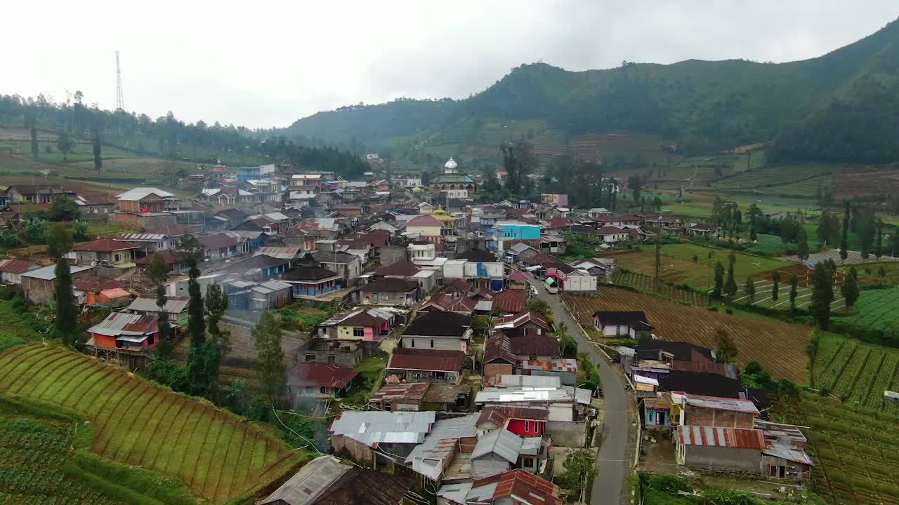 Aerial view of traditional village surrounded by hills on Java island ...