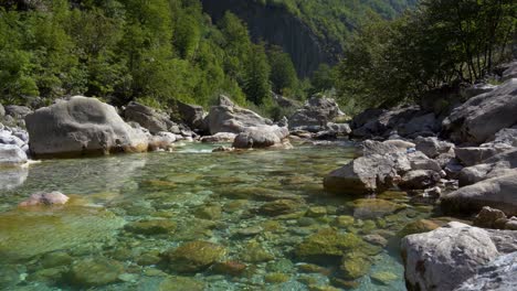 alpine river on high mountain with turquoise crystal cold water streaming through cliffs