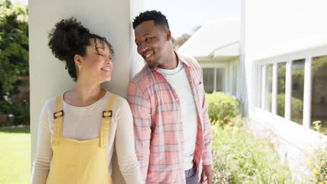 Portrait-of-happy-african-american-couple-embracing-in-garden-at-home,-slow-motion