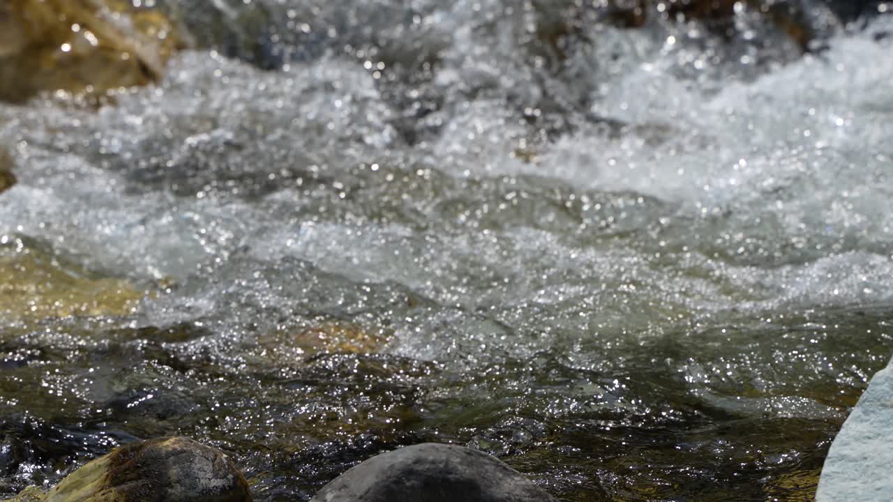 Water is flowing through a mountain torrential river.