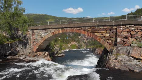 flight under old bridge spanning bjoreio river, towards viewing platform, voringsfossen