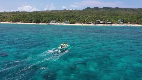 Barcos-De-Pasajeros-Tradicionales-De-Filipinas-Moviéndose-Hacia-La-Orilla-Del-Mar-Vista-Aérea-De-Primer-Plano