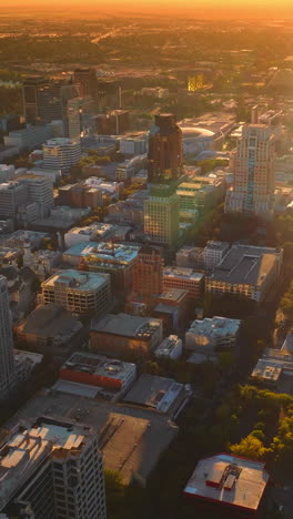 sacramento downtown with high buildings. amazing city scenery in the orange light of setting sun. red skies at backdrop. vertical video