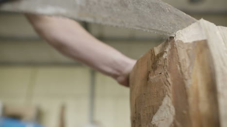 Carpenter Cutting Wood With Handsaw In Workshop 1