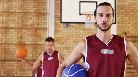 confident basketball player holding a basketball