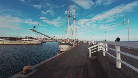 tall ship docked at a marina pier