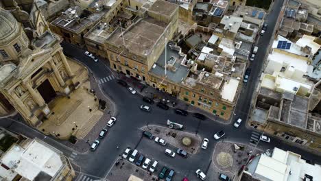 zoom-out to a city roundabout intersection in mediterranean city area suburbs, infrastructure in southern europe