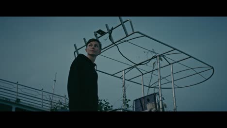 person near an abandoned boat at twilight