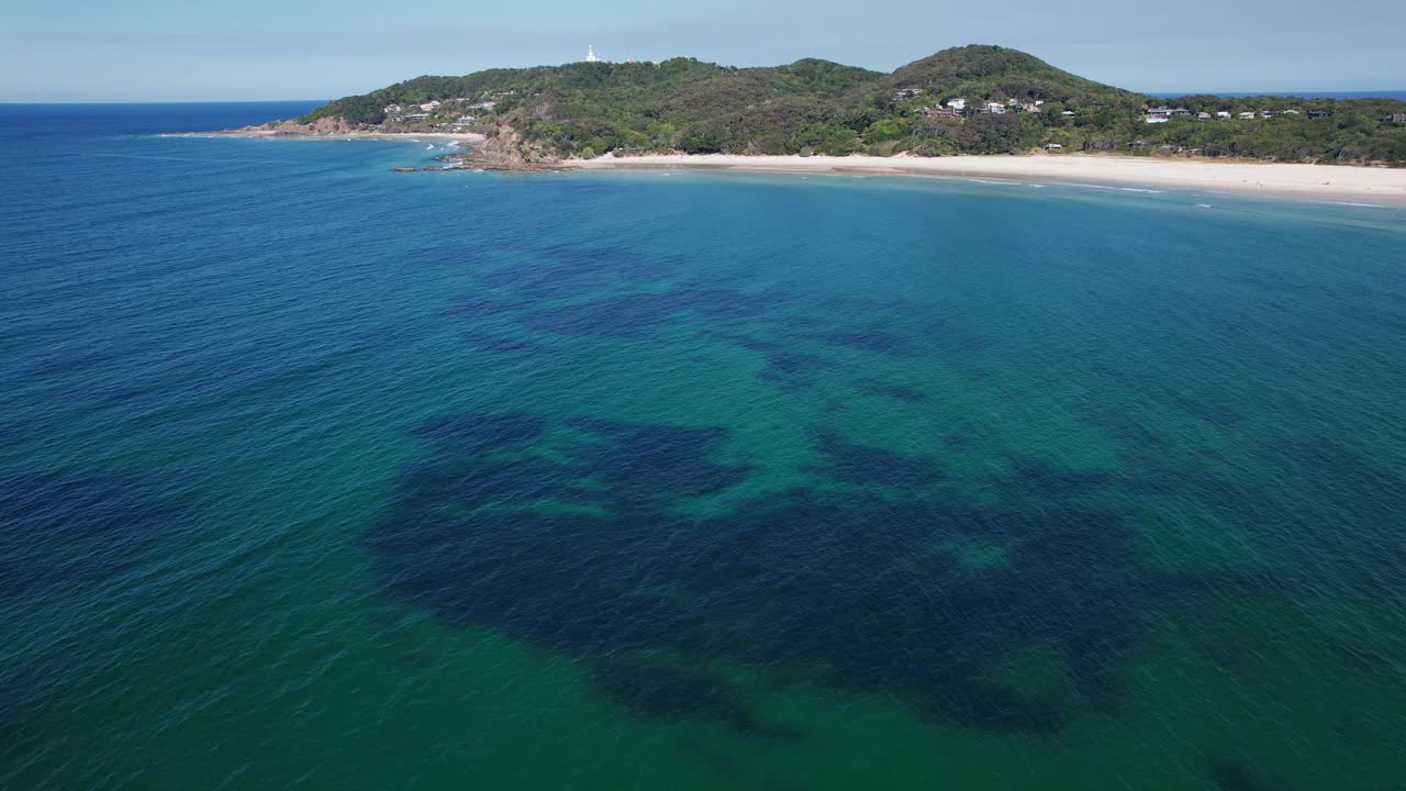 Blue Ocean With Distant View Of The Pass And Fisherman's Lookout On Byron Bay, NSW, Australia
