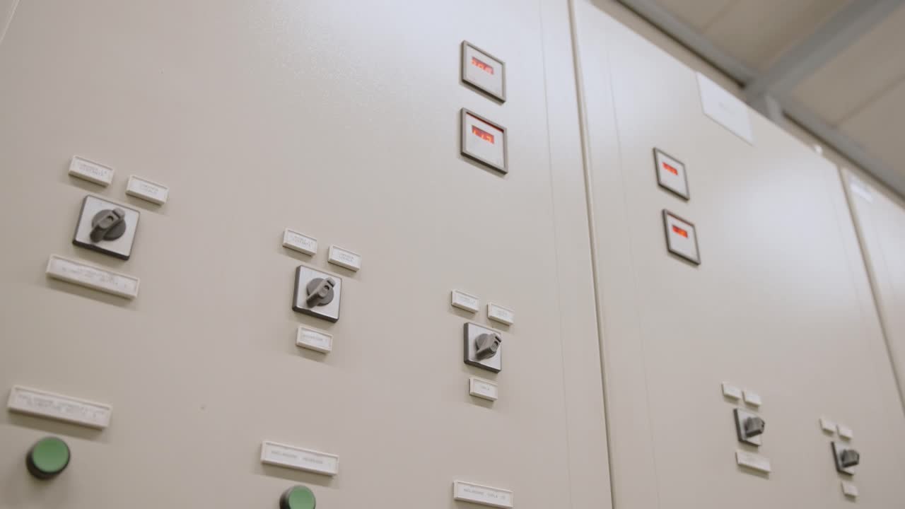 Industrial control panel with multiple buttons and switches, indoor view