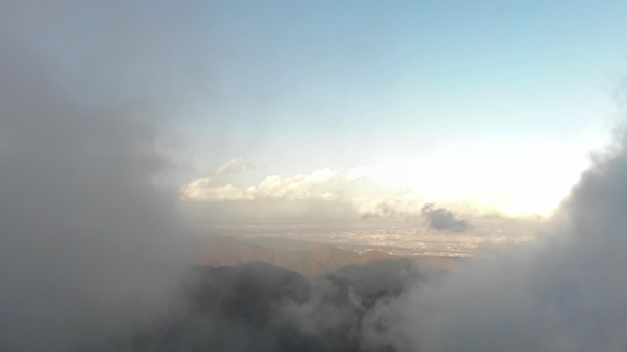 Flight over beautiful clouds in the mountains - Wide Shot