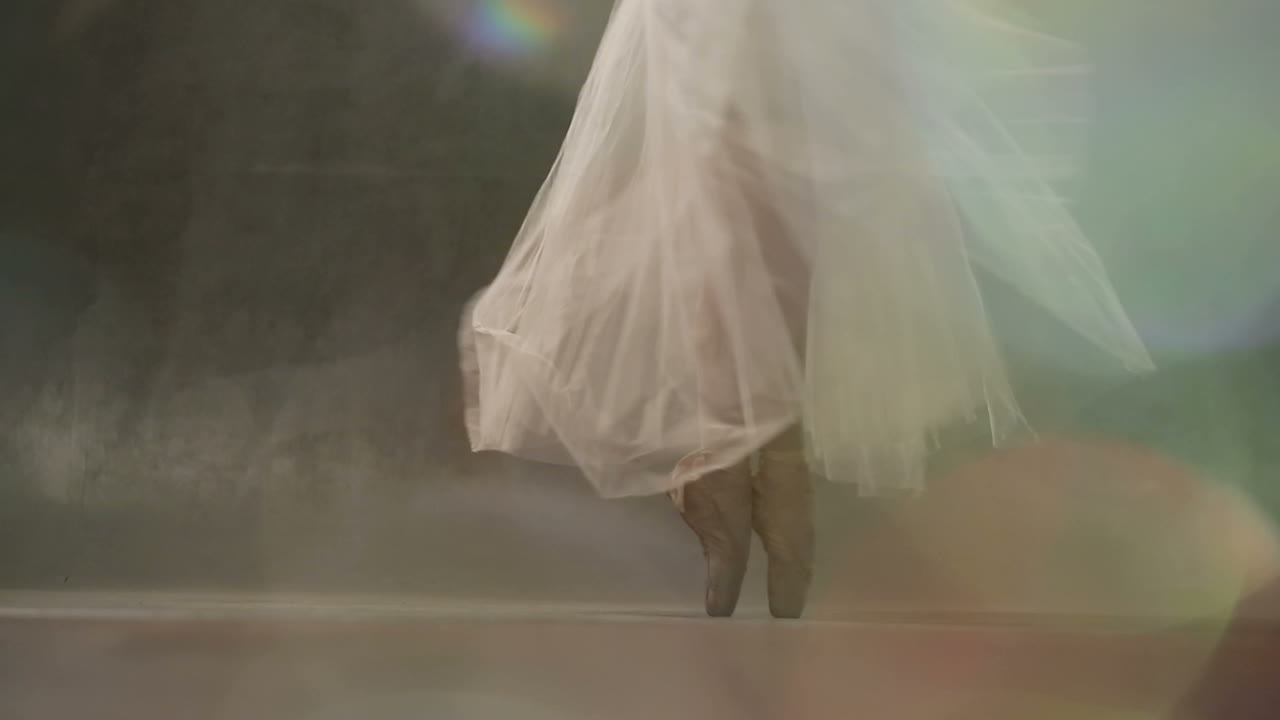 Ballet Dancer Action. Pretty young ballerina wearing a tutu in a dance studio