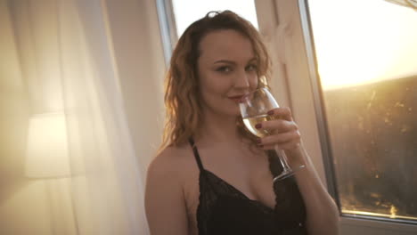 woman enjoying wine by the window
