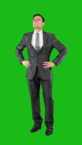 businessman in suit posing and expressing emotions on green screen