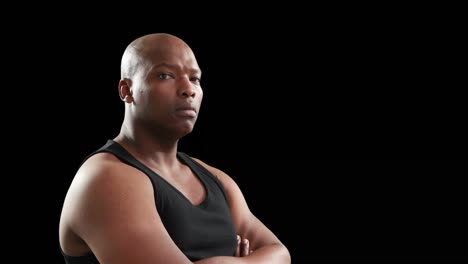muscular man with arms crossed looking at camera