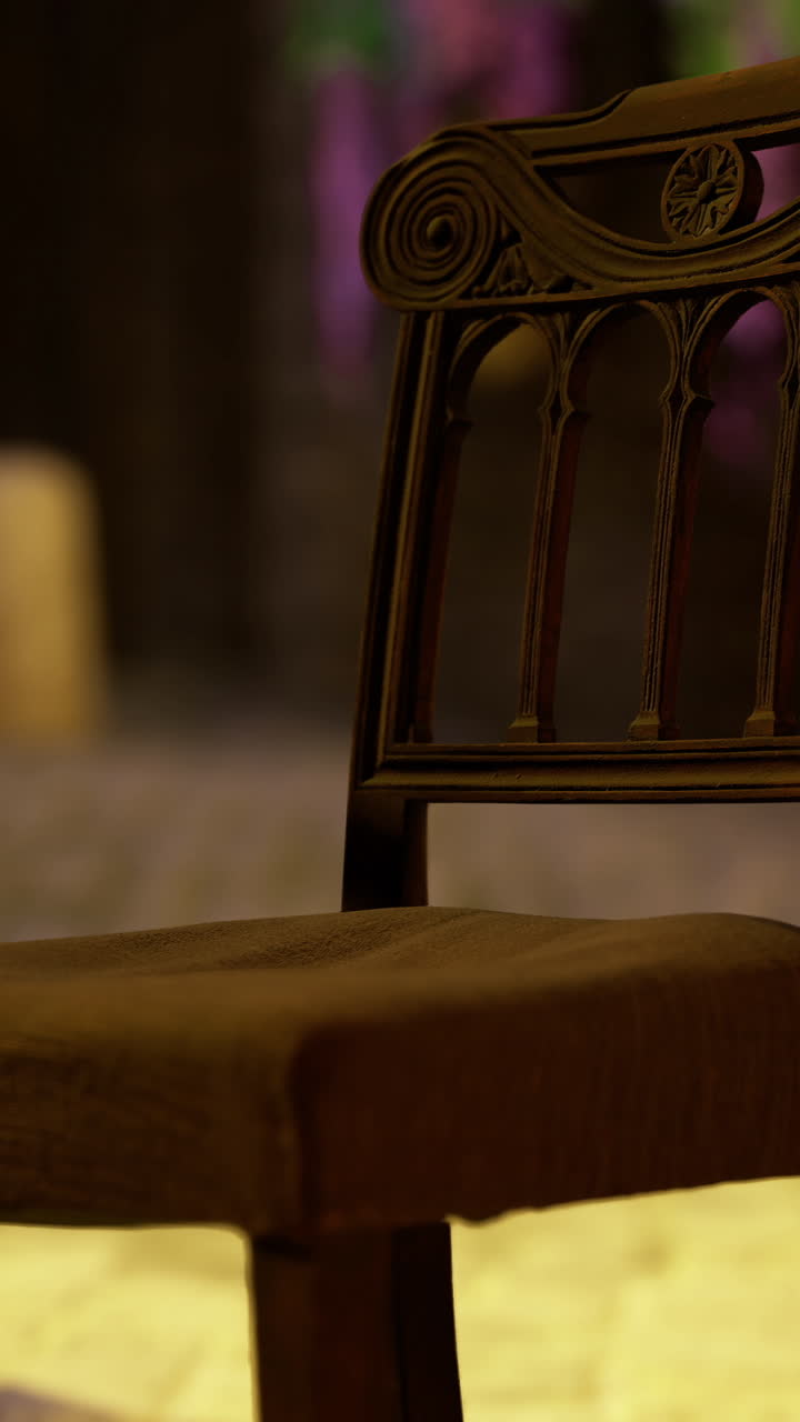 Old wooden chair placed on cobblestone street near historic building at sunset