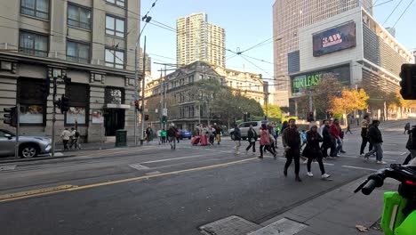 pedestrians and vehicles at a bustling intersection