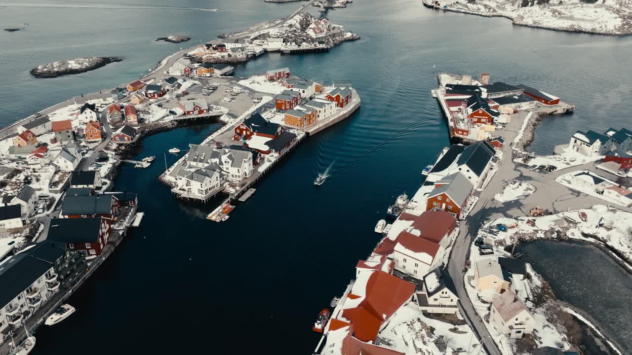 Motor Boat Heading To The Marina In Henningsvaer Village In Nordland, Norway. - aerial shot