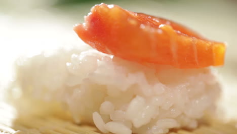 putting piece of salmon on the rice