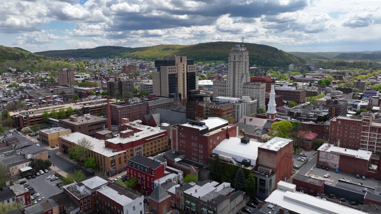 Downtown Cityscape with Rolling Hills and Cloudy Sky