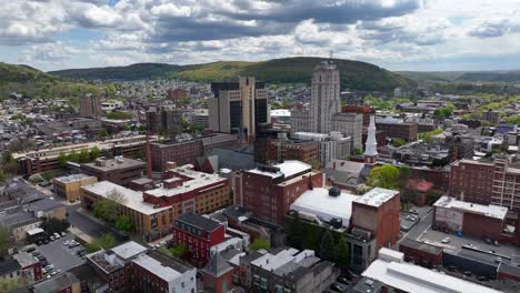 downtown cityscape with rolling hills and cloudy sky