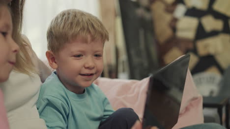 cute toddler and preschooler talk while watching videos