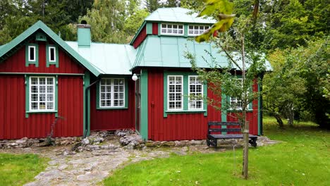 snow white house, famous cottage amidst a beautiful dense green forest on a dazzling day