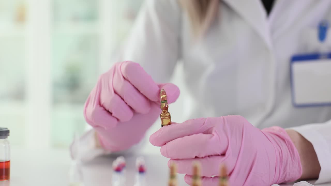 Medical research with ampoules and gloves