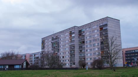 Beautiful-timelapse-view-of-fast-moving-rain-clouds-over-old-Soviet-time-apartment-buildings-in-Liepaja-city,-overcast-day,-wide-angle-shot