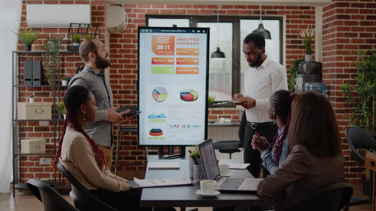 Diverse team of men explaining data analysis with charts