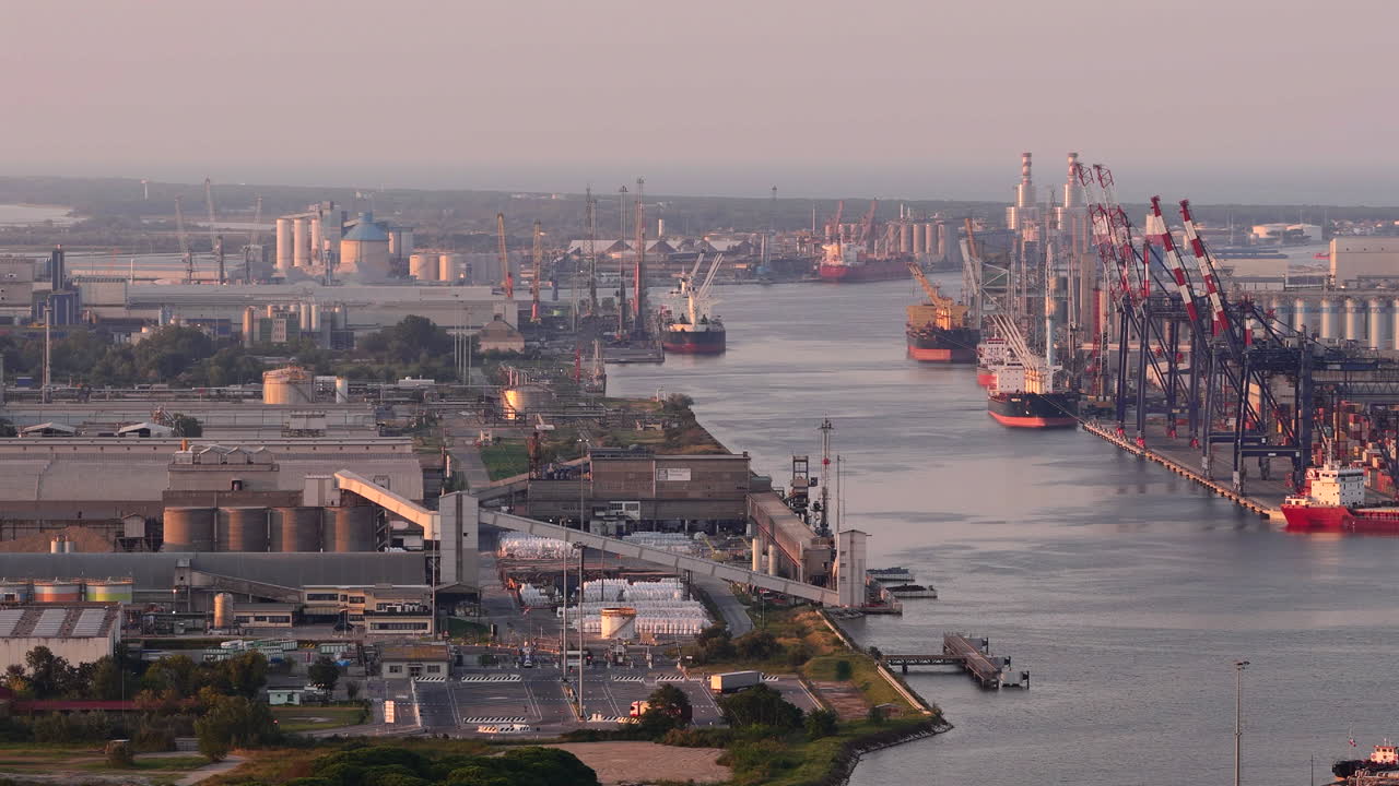 Nice aerial view of industrial and port area of Ravenna,production district is made up of a chemical and petrochemical pole, thermoelectric and metallurgical plants at sunset