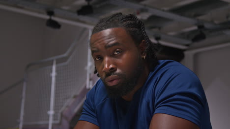 close up portrait of determined male athlete sport training in gym sitting and concentrating in changing room with focused expression 6