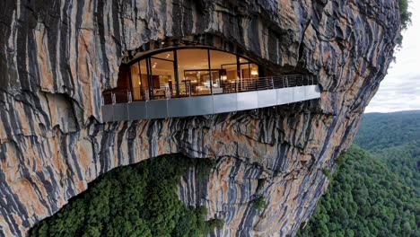 luxury cave hotel on a cliffside in a rainforest