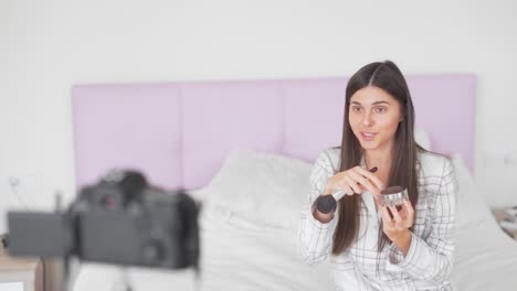 pretty girl talks on camcorder about face powder