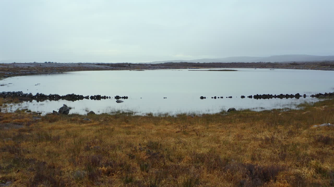 Aerial dolly gliding towards the Turlough at Mullaghmore. Burren, County Clare