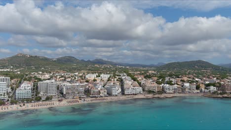 mallorca: aerial view of resort town son servera on majorca island, spain, europe | city and mountainside follow