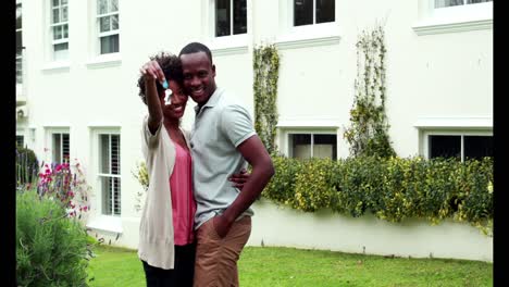 happy couple outside their new home