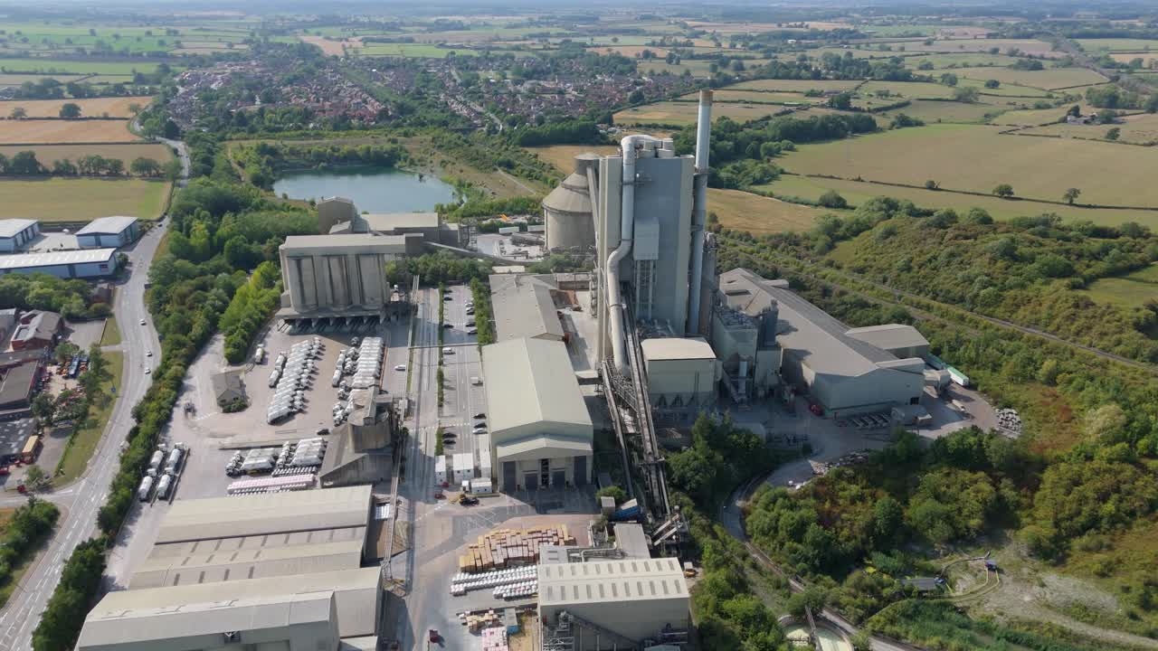 Industrial cement manufacturing factory and aggregates plant aerial drone view in Rugby England UK during bright summer weather