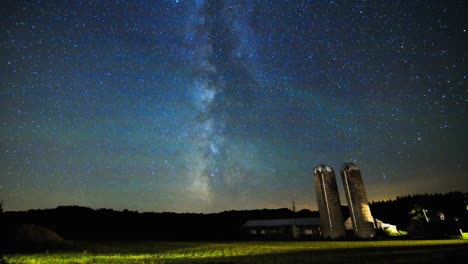 milky way time lapse sliding over farm silos and field