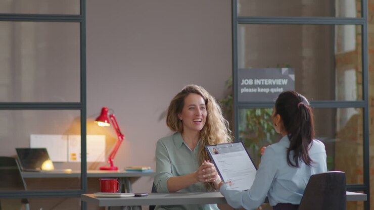 Woman Walking in Office and Talking to Recruiter on Job Interview