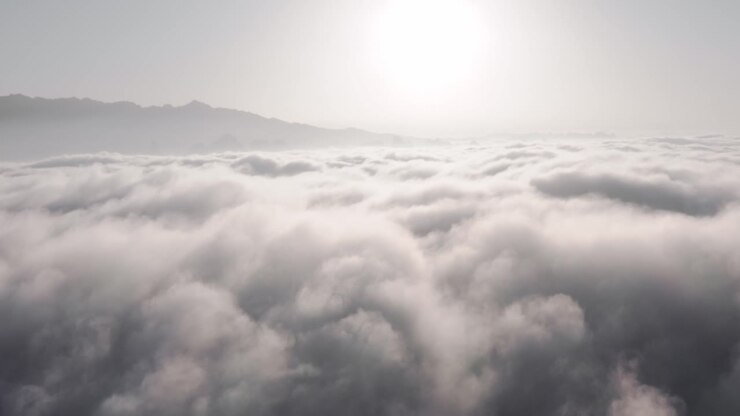 Dramatic clouds over Xianggong Mountain in China, aerial view above clouds